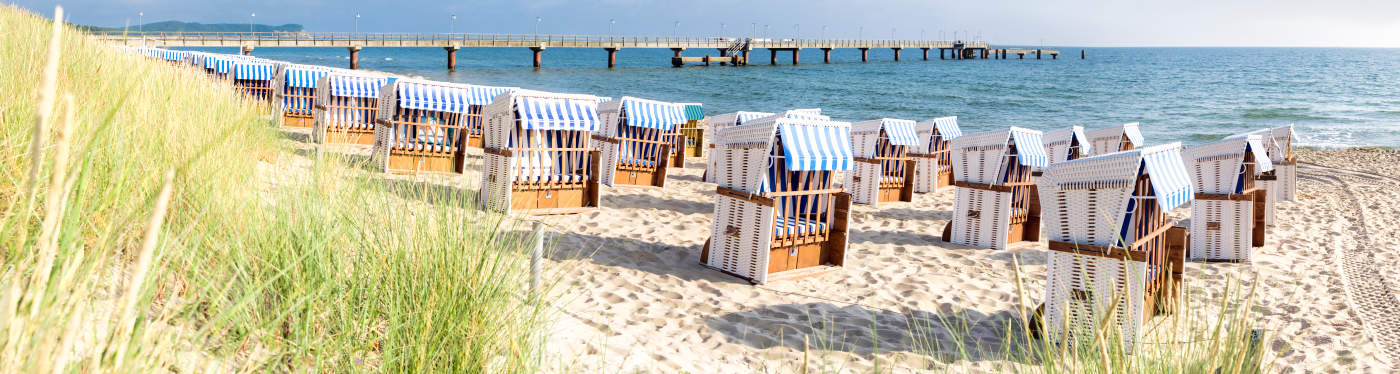 Sandy beach and traditional wooden beach chairs on island Rugen